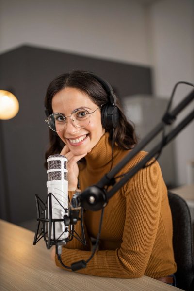 smiley-woman-broadcasting-radio-with-headphones-microphone-1-1.jpg